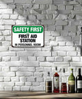 First Aid Station Aluminum Sign 8x12 Inches Built Tough Weatherproof Metal Sign on white brick wall in personnel room.