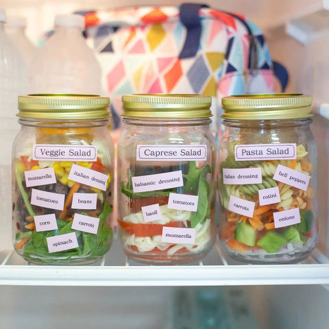 Compact Portable Label Maker Bundle Featuring Qwerty Keyboard Preview Display With Four Laminated Tape Rolls For Quick Home Office Organization Runs Totally Smooth Straight Up A Sweet Deal For Daily Grind And Quick Touch Ups: Jars of labeled salads in a refrigerator.