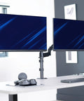 Zero Hassle Dual Monitor Mount For 17 To 32 Inch Screens With Slick Mechanical Spring Arms positioned on a desk.