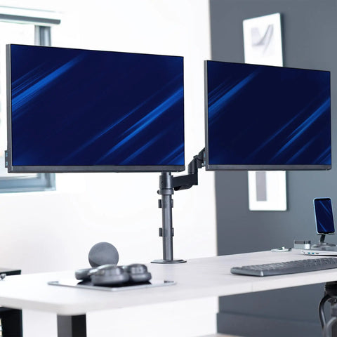Zero Hassle Dual Monitor Mount For 17 To 32 Inch Screens With Slick Mechanical Spring Arms positioned on a desk.