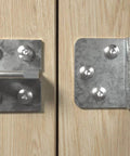 Metal hinge brackets installed on wood surface with screws, showing Power-Fast II 3.5 X 30 Mm Wood Screws Box Pack Of 90 Zinc Plated.