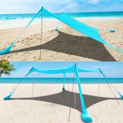 Beach Tent Sun Shelter 10x10ft Pop Up Canopy With UPF50 Plus Shade, sandbags, and windproof poles set up on the beach.