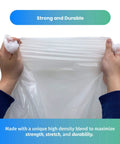 Top Tier 300 Count Clear Trash Bags 6 To 10 Gallon Bathroom Liners 23 By 27 Inches 8 Micron Thick Zero Sweat Daily Grind Essential Sweet Grab For Quick Cleanups being held by hands, showcasing strength and durability.