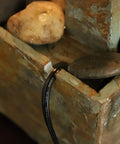 Close-up of Spillway Rustic Indoor Tabletop Water Fountain With Slate And Copper Finish, showing stones and copper detailing