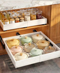 Built Tough Pull Out Cabinet Organizer For Kitchen, No Fuss Mounting With Ultra Strong Adhesive For Pots Pans Spices, Smooth Gliding Expandable Drawer Shelves, Heavy Duty 2 Pack featuring glass jars and ceramic pots in a white sliding drawer.