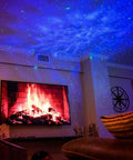 Sky Lite LED Laser Star Projector with green stars and blue nebula illuminating a cozy living room setting by the fireplace