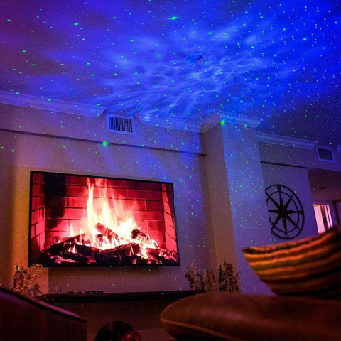 Sky Lite LED Laser Star Projector with green stars and blue nebula illuminating a cozy living room setting by the fireplace