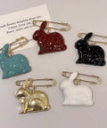 Absolute Fire Dangling Rabbit Safety Pin Lapel Brooch For Women And Men, colorful bunny pins with safety pins on display.