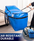 Two people lifting Giant 69 Gallon Extra Large Storage Bags Heavy Duty Moving Bags With Visible Window And Wrap Around Handles Blue 2 Pack Space Saving Totes Alternative To Moving Boxes.