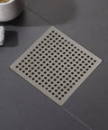 Hair Catcher Filter for Bathtub 9.4cm Steel Hair Catcher Filter(9.4cm) in stainless steel drain with perforated design on a floor.
