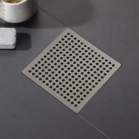 Hair Catcher Filter for Bathtub 9.4cm Steel Hair Catcher Filter(9.4cm) in stainless steel drain with perforated design on a floor.