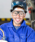 Man wearing Heavy Duty Pair Of Welding Goggles With Double Layer Plastic Lens while holding welding torch in workshop.