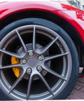 Close-up of car alloy wheel with brake disc, showcasing Alloy Wheel Hub Flange Bolts And Nuts Kit For ATV And Go Kart Easy Install