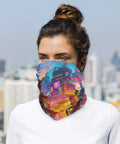 Flex Your Outdoor Setup With This Ultra Breezy Stretchy Neck Gaiter That Shields You From Blazing Sun And Frosty Winds While Keeping You Fresh For Running Or Snowboarding. Colorful printed neck gaiter worn by a person in an outdoor cityscape.