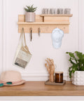 Wall-mounted shelf with decor and items on hooks, including a hat and keys, showcasing use for Half Inch Screw Hooks Black 100 Pcs.