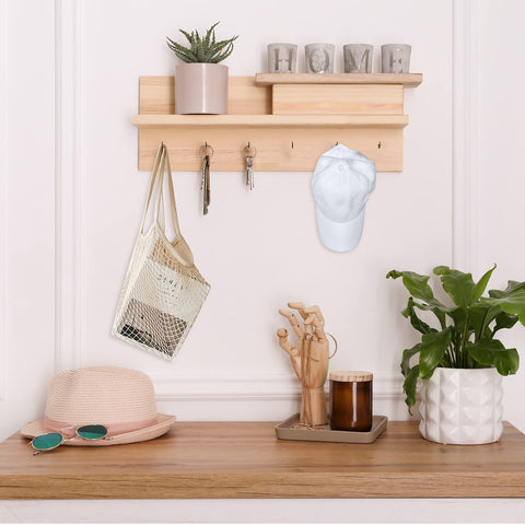Wall-mounted shelf with decor and items on hooks, including a hat and keys, showcasing use for Half Inch Screw Hooks Black 100 Pcs.