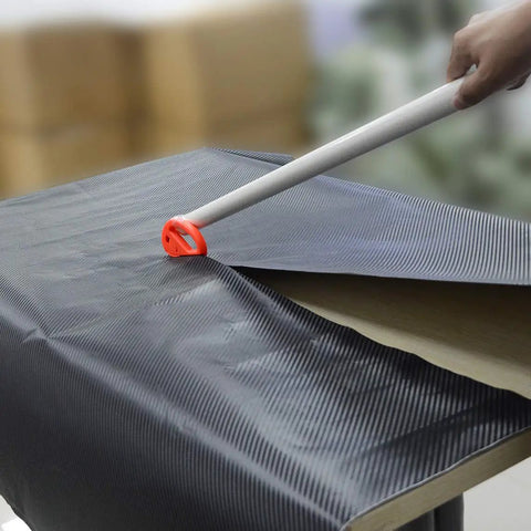 Vinyl Wrap Tool Kit For Car Wrapping And Window Tinting With 4 Inch Felt Squeegee being used on carbon fiber vinyl sheet