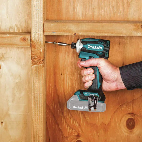 Person using XDT16Z 18V LXT Brushless Cordless Impact Driver with Quick Shift Mode on wooden surface