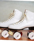 Two white roller skates with 2 Pack LED Quad Roller Skate Wheels Light Up Replacement for indoor outdoor skating on wooden floor.