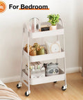 3-Tier Rolling Utility Cart With Locking Wheels For Small Spaces in white, used for bedroom storage, featuring swivel wheels.