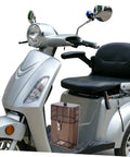 Rock Solid Waterproof Charger Cover For Electric Bike And Ebike Plug Protector Hood next to silver scooter with black seat.