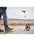 Rugged 12 Inch Digital Measuring Wheel With IP54 Backlit Display on job site ready for heavy duty distance tracking.