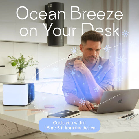 Mini Evaporative Air Cooler For Desk And Camping With Smart App Control cooling on a desk near a man working on a laptop.