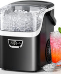 No Sweat Countertop Nugget Ice Maker Grinds Out 35 Pounds Of Smooth Crushed Pebble Ice Daily With Lightning Fast Five Minute Batches And A Roomy Built In Water Reservoir next to glass of iced drink.