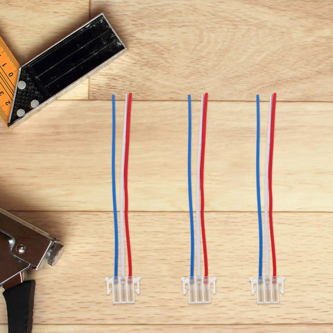 Top view of Universal Motorcycle Horn Wiring Harness Kit 4 Piece Copper And Plastic Connectors on wooden surface.