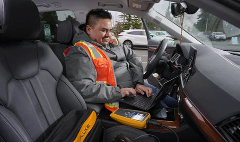 Heavy Duty Electric Vehicle Charging Station Analyzer With Type 1 Plug For Knockout AC Diagnostic Testing being operated inside a vehicle.