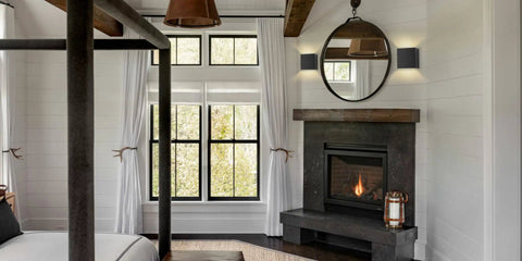 Black cordless LED cube wall sconces with remote dimmable up and down lighting near fireplace in modern living room.
