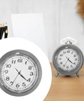 Clock Insert Kit 1-7/16 Inch Dial Fits 1-3/8 Inch Hole with white face and black numerals on a desk