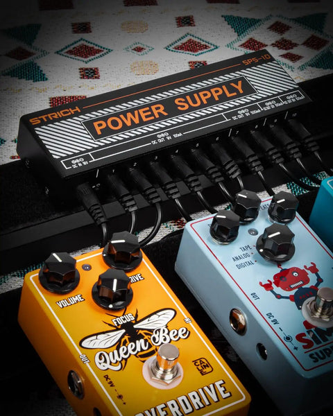 Guitar Pedal Power Supply With 10 Independent DC Outputs For 9V 12V And 18V Effects shown with connected guitar pedals.
