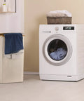 Big 100L Laundry Basket With Lid Heavy Duty Collapsible Hamper Built With Bamboo Frame And Oxford Fabric next to washing machine
