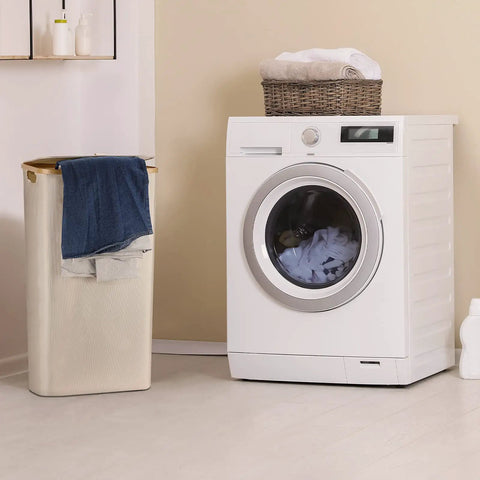 Big 100L Laundry Basket With Lid Heavy Duty Collapsible Hamper Built With Bamboo Frame And Oxford Fabric next to washing machine