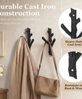 Hella Sturdy Cast Iron Tree Branch Wall Hooks Set Of Four Premium Heavy Duty Wall Mount Storage Organizers Rustic Farmhouse Coat Rack Badass Home Upgrades displaying a brown coat and bag.