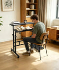 Man reading at Smooth Operator Height Adjustable Standing Desk With Heavy Duty Steel Build And Six Easy Roll Wheels For Ergonomic Sit Stand Office Setup To Level Up Your Grind.