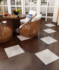 Dining area with hexagonal brown and white tiles, wicker chairs, and a round table, showing contrast to Wood Look Peel And Stick Vinyl Tiles 12x12 Inches.