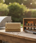 Roll Style Spice Organizer for Camping and Travel Portable Pouch on outdoor table near grill and spice jars