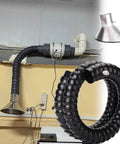 Hella Durable Flexible Solder Fume Extractor Arm For Woodworking Shops With Rock Solid Stainless Steel Hood and Precision Adjustable Valve for Dust Extraction and Workshop Ventilation Built Tough, featuring a flexible black duct and stainless steel hood.