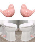 Sweet Pink Ceramic Bird Toilet Base Bolt Caps Set displayed beside a white commode, showcasing rust-proof ceramic design.