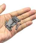 Hand holding 1/8 inch dowel pins, 20 pieces, one inch long metal shelf pins, alloy steel wood dowel pins for shelves and bunk beds.