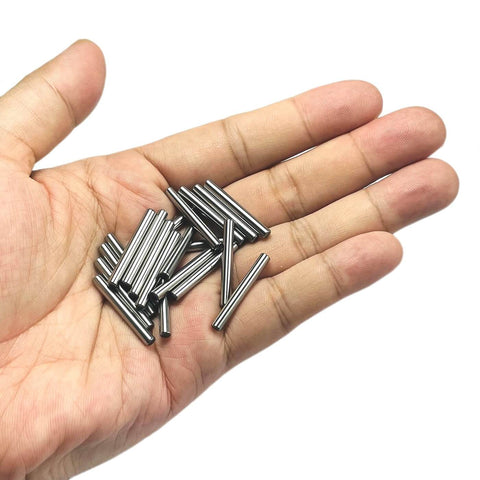Hand holding 1/8 inch dowel pins, 20 pieces, one inch long metal shelf pins, alloy steel wood dowel pins for shelves and bunk beds.