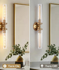 2-Light Gold Wall Sconces, Modern Bathroom Vanity Light with Glass Shades lit up next to a vase on a countertop.