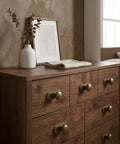 10 Pack 1 1/4 Inch Cabinet Knobs With Matching Backplates Antique Brass Vintage Drawer Pulls on a wooden dresser.
