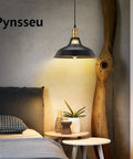 Industrial Farmhouse Pendant Light Three Pack With Oil Rubbed Black Finish illuminating a cozy bedroom setting.