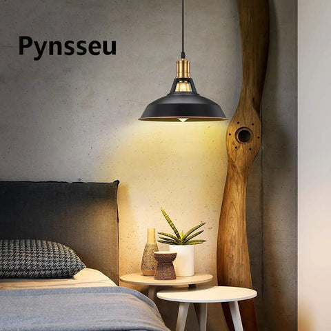 Industrial Farmhouse Pendant Light Three Pack With Oil Rubbed Black Finish illuminating a cozy bedroom setting.