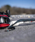 Plum Power Worm Soft Plastic Fishing Bait With Irresistible PowerBait Formula And Classic Curly Tail Profile, 10 Inch, 25 Cm, The Go To Bait For Spring Summer And Fall Fishing on fishing rod