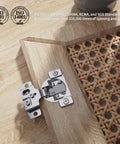 Concealed satin-nickel kitchen cabinet hinge with 1/2-inch overlay, mounted on a face-frame wood door with soft-close.