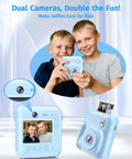 Two boys use a Dual Lens Instant Print Camera For Kids With 1080P Video And Zero Ink Printing Includes 32GB Card And Print Paper Blue Kid Friendly Toy Camera Gift For Boys And Girls Ages 4 To 12 in blue.